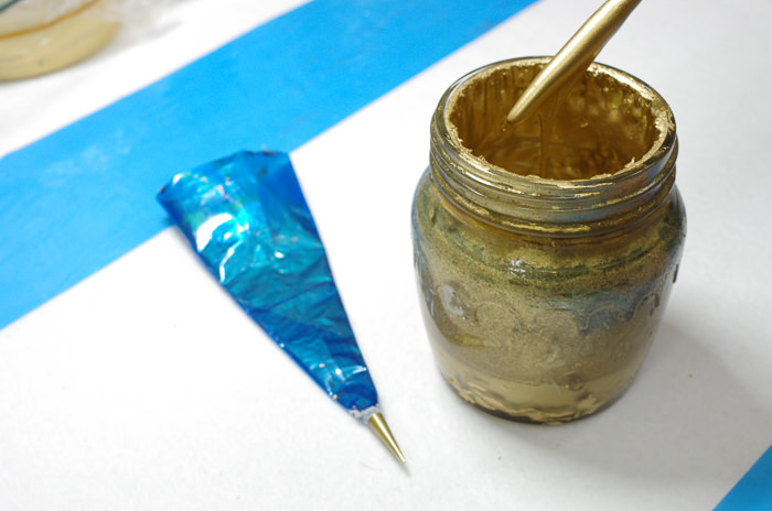 mixing metallic powder and an adhesive agent